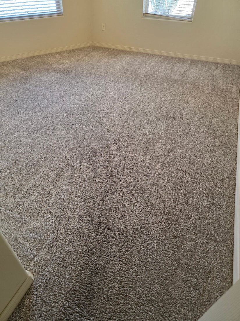 Empty carpeted room waiting for staging furniture to be carried in