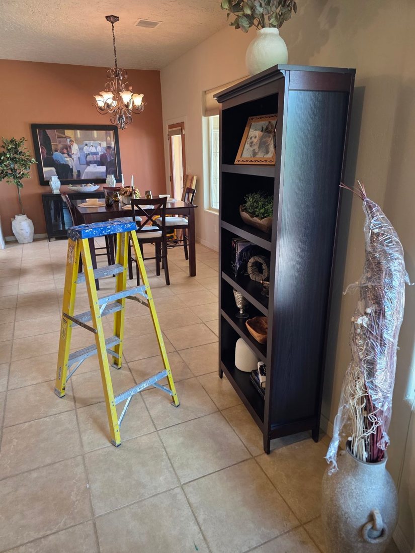 Bookcase set in place with a ladder still out mid-setup