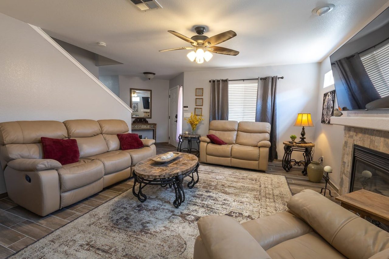 Open family room with leather sofas and fireplace, Kingston House Las Cruces NM