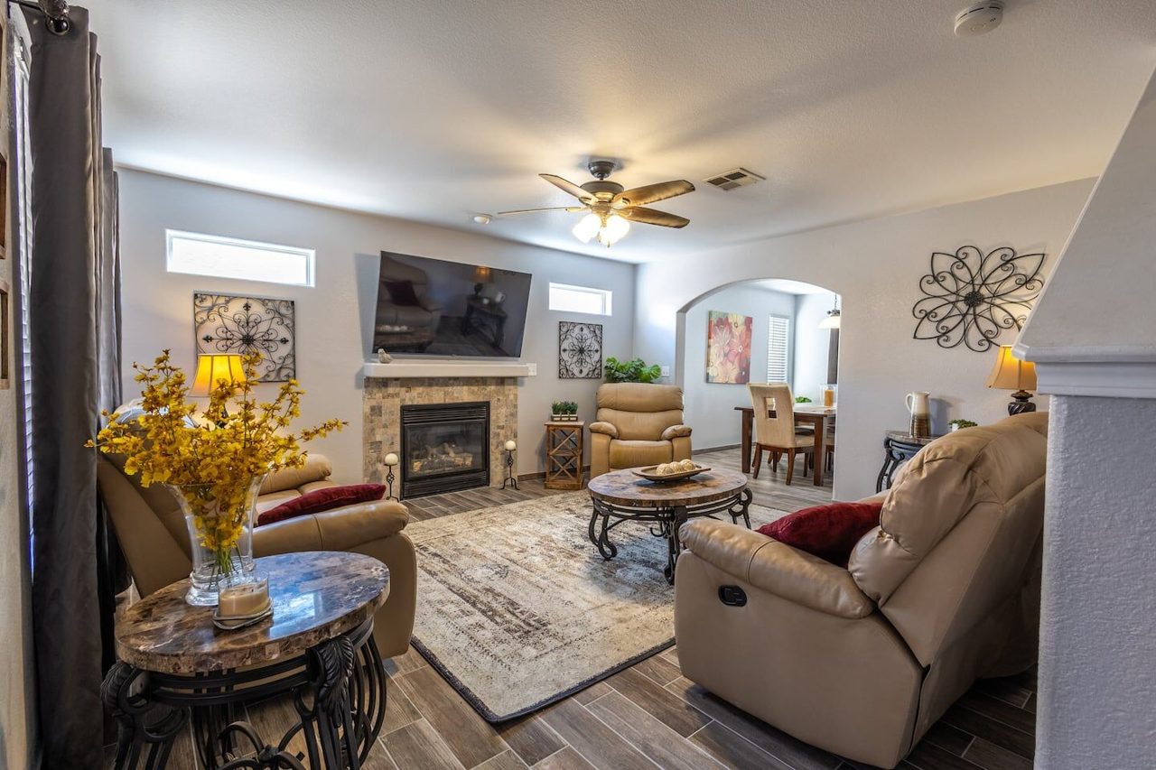 Living room with fireplace, recliners and area rug at the Kingston House vacation rental in Las Cruces NM