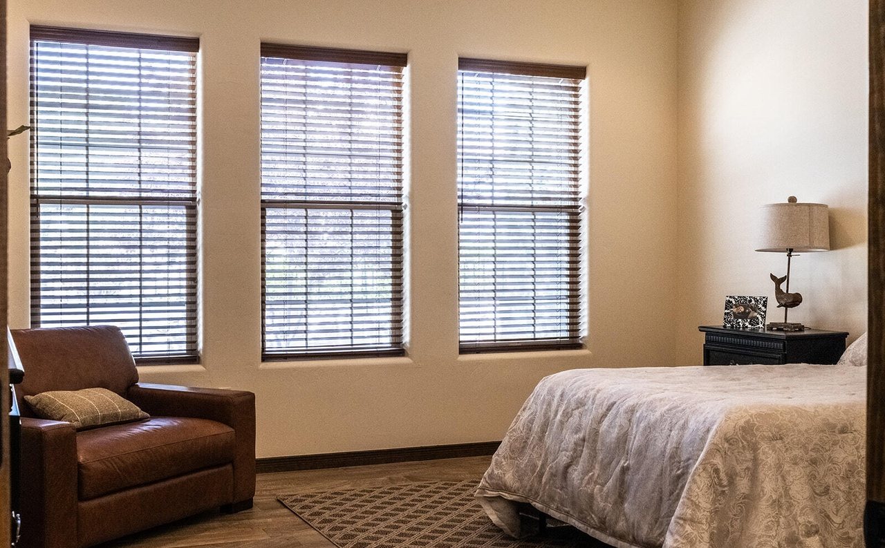 Staged bedroom with leather reading chair and real bed, Sedona Boulders Las Cruces