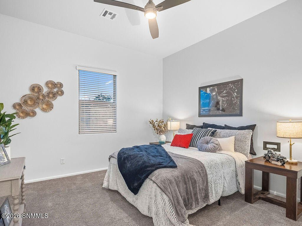 Staged guest bedroom with layered bedding and lamps, Villa Napoli Las Cruces