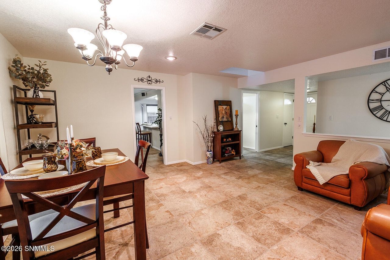 Staged dining room and living room with chandelier, Las Cruces home staging