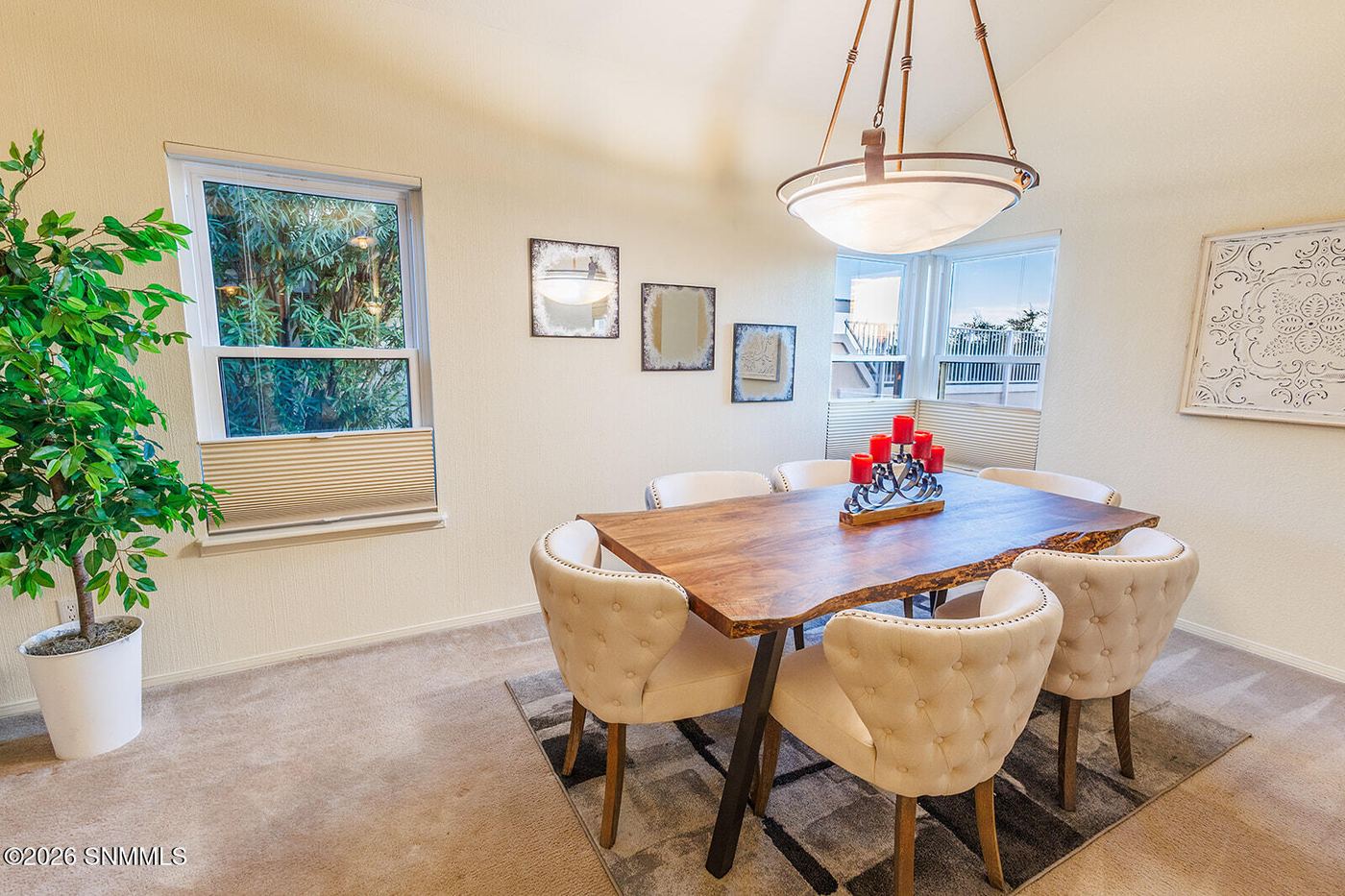 Staged dining room with table, chairs and chandelier in a Las Cruces listing