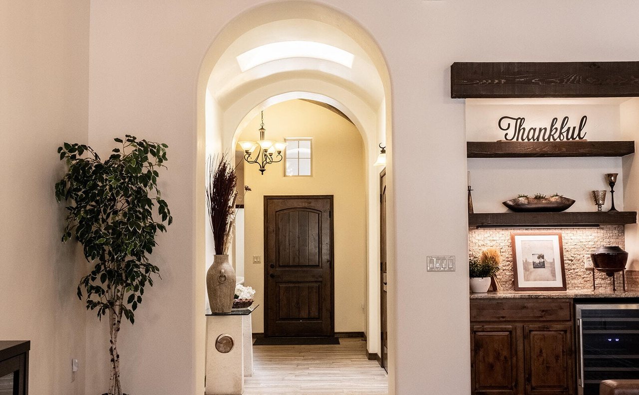 Staged entry with arched hallway, plant and styled shelves, Sedona Boulders home staging Las Cruces NM