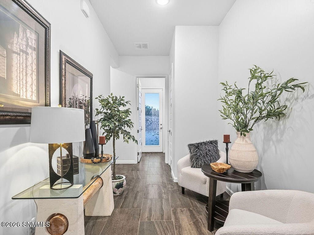 Staged entry with console, lamp and white accent chairs, Villa Napoli Las Cruces NM