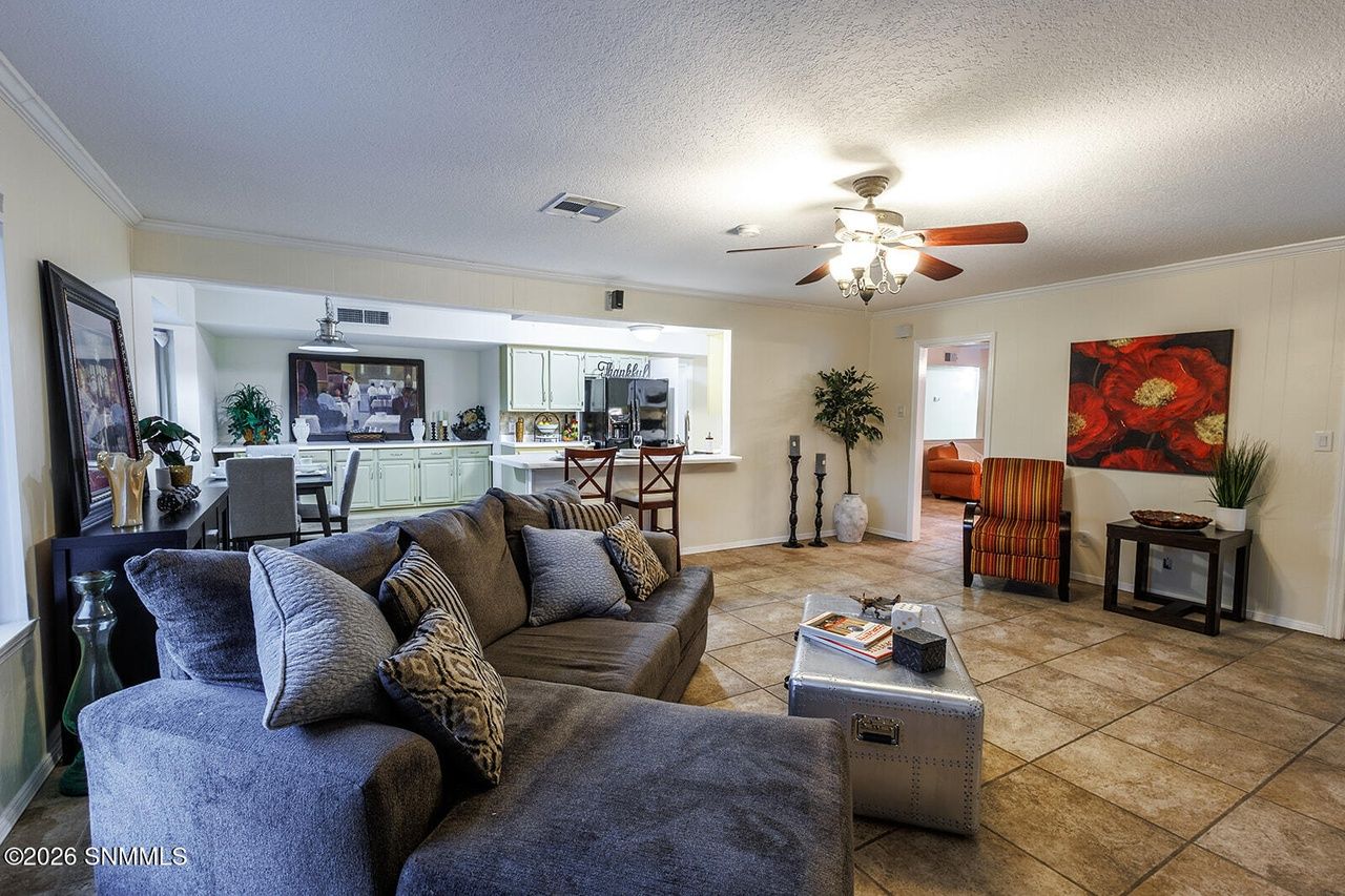 Staged family room with sectional sofa and open kitchen, full-home staging Las Cruces NM