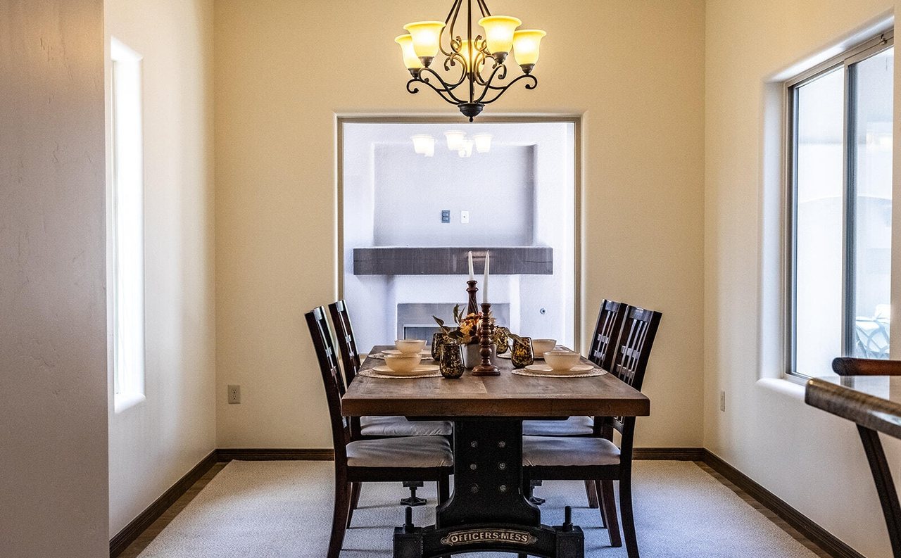 Staged formal dining room with trestle table and chandelier, Sedona Boulders Las Cruces NM