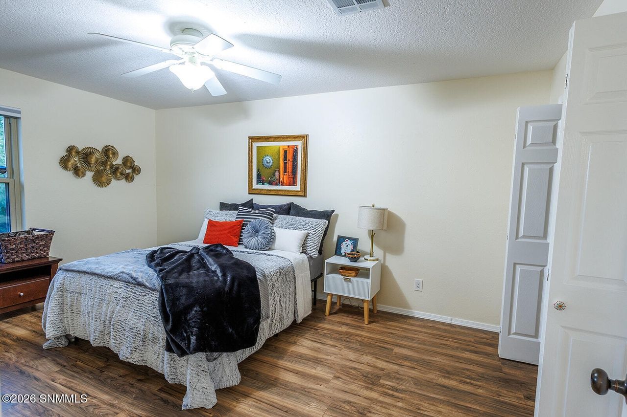 Staged guest bedroom with layered bedding and nightstands, Las Cruces NM