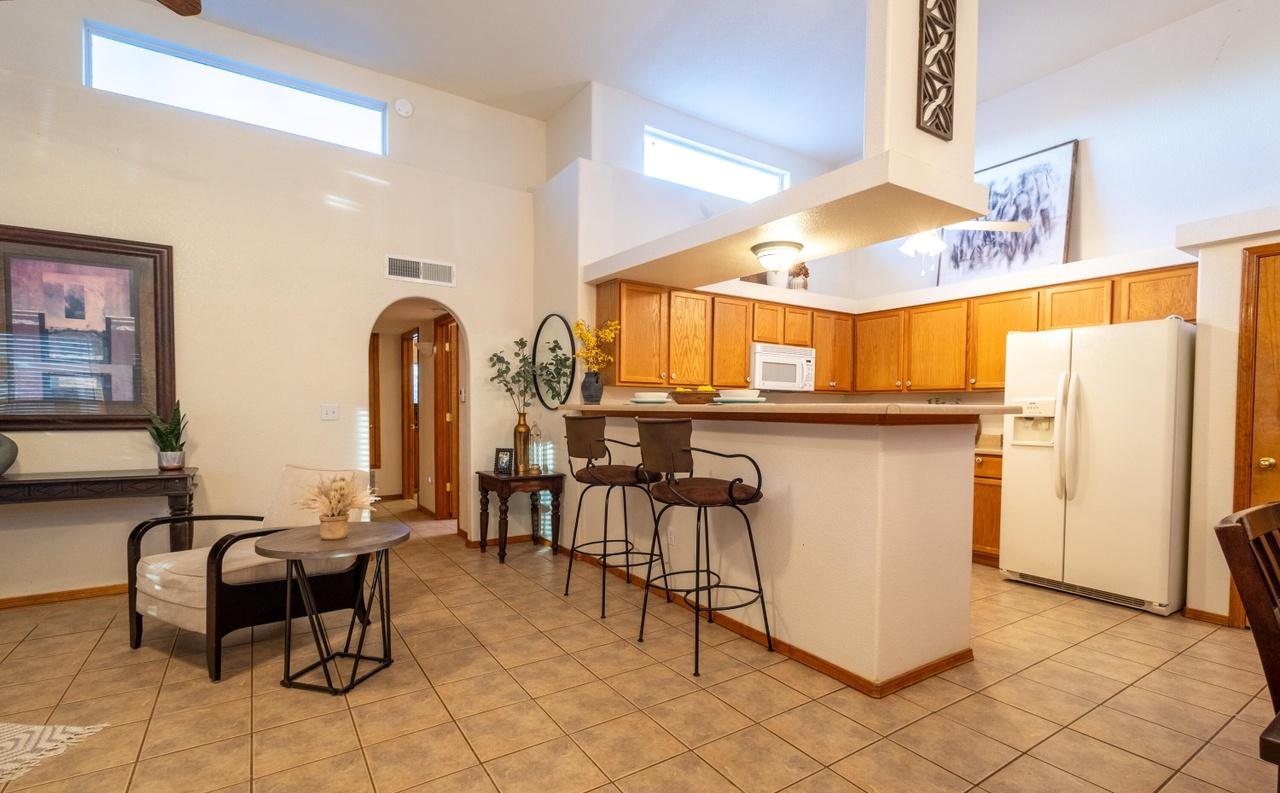Staged kitchen and breakfast area with bar stools and bistro chairs, Foxtail Pine Las Cruces