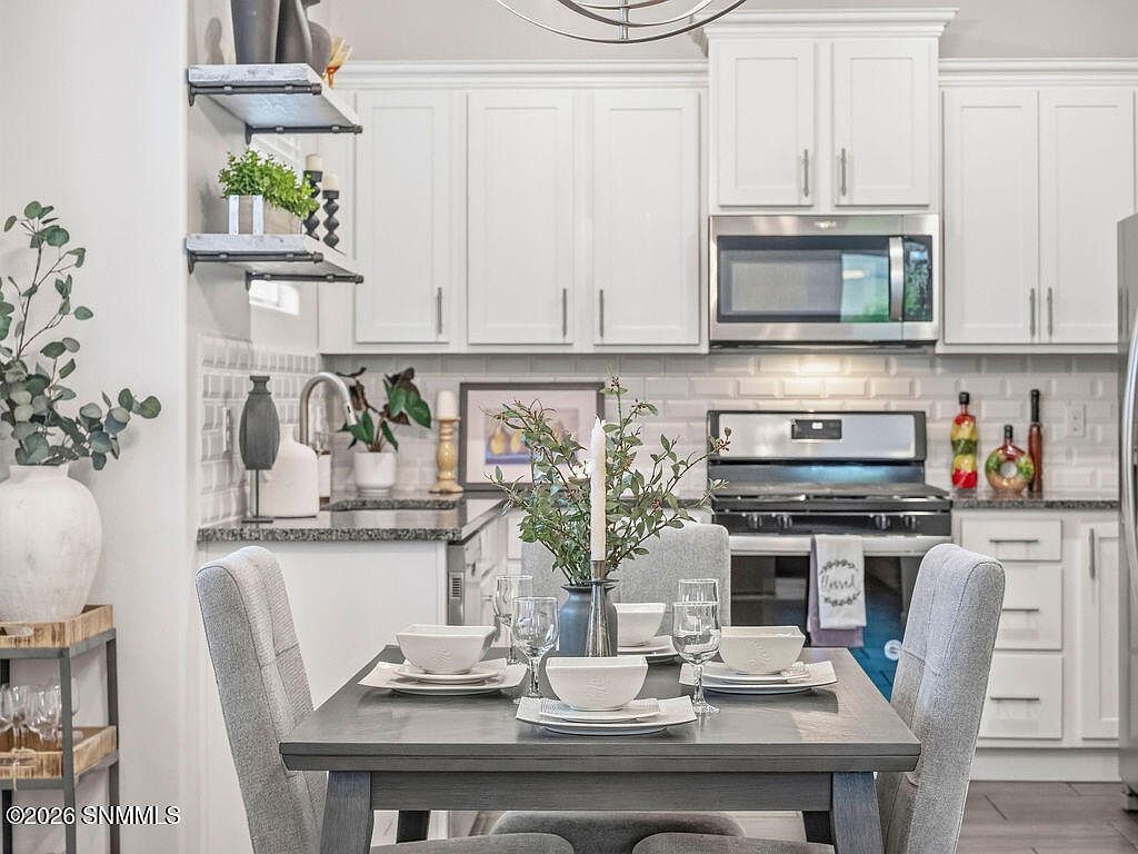 Staged kitchen and dining table set with place settings, Las Cruces NM