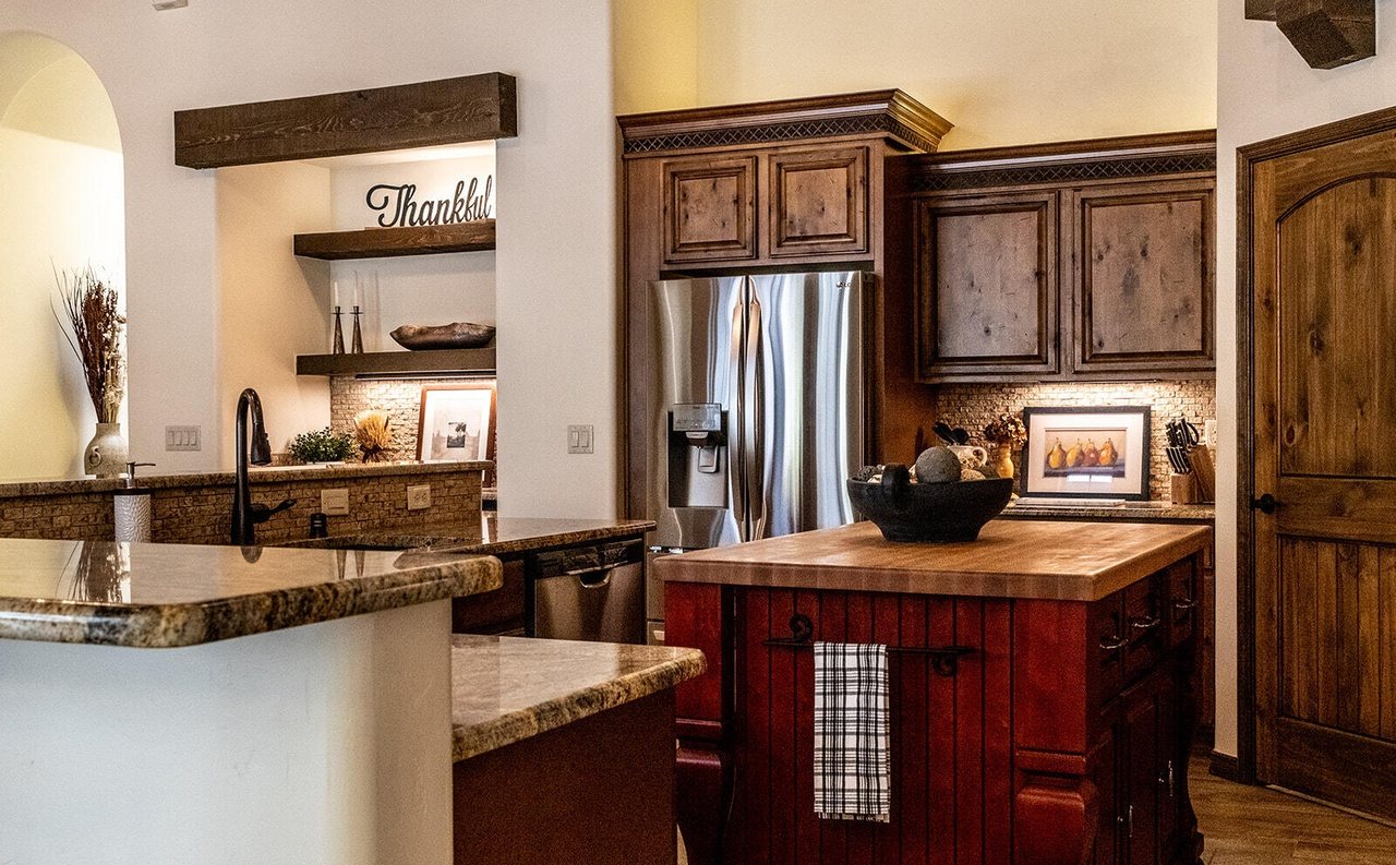 Staged kitchen with butcher-block island and styled shelves, Sedona Boulders Las Cruces