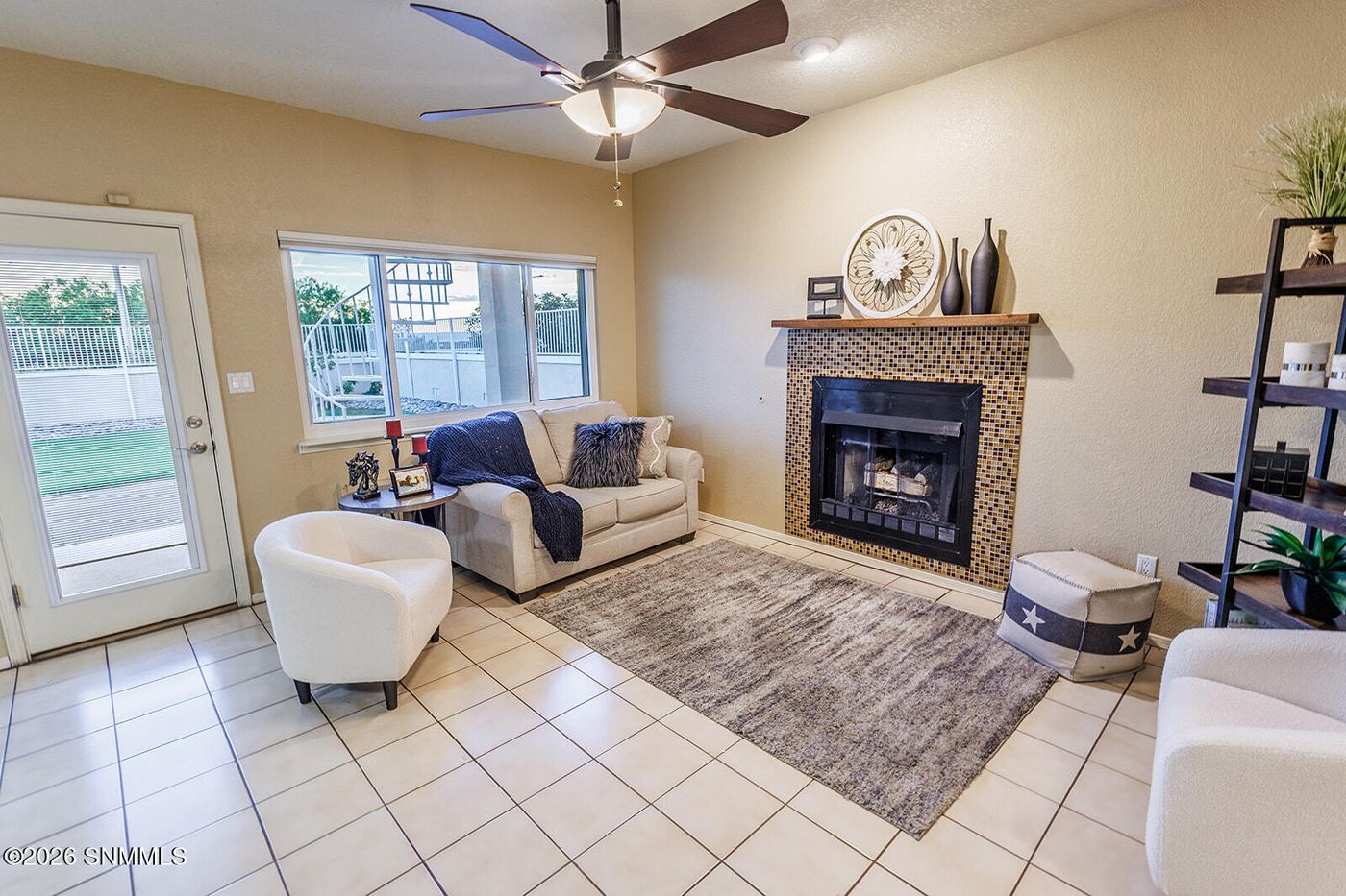 Staged living room with fireplace and styled shelving, Las Cruces home staging