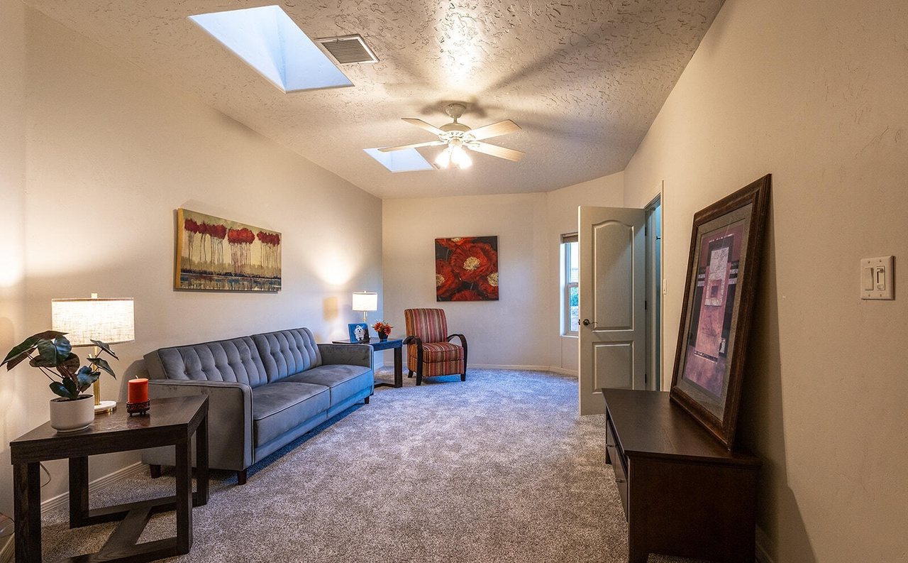 Staged second living room with gray sofa, lamps and art, Sedona Hills Las Cruces NM