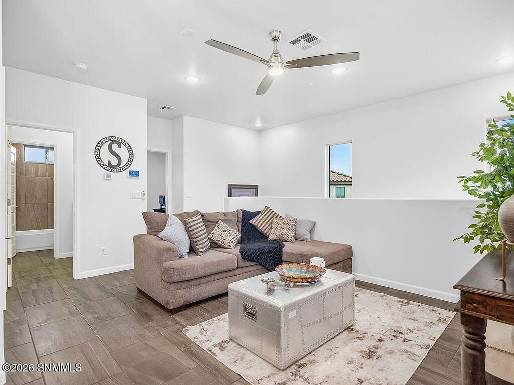 Staged living room with sofa, ottoman and area rug at 2005 Villa Napoli Loop, Las Cruces NM