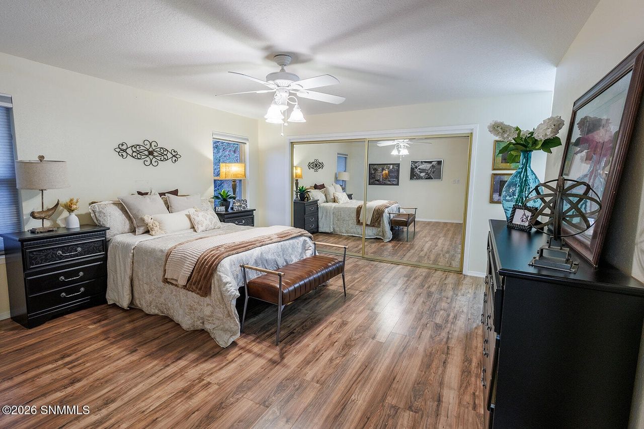 Staged primary bedroom with a real bed, bench and dressers, Las Cruces home staging