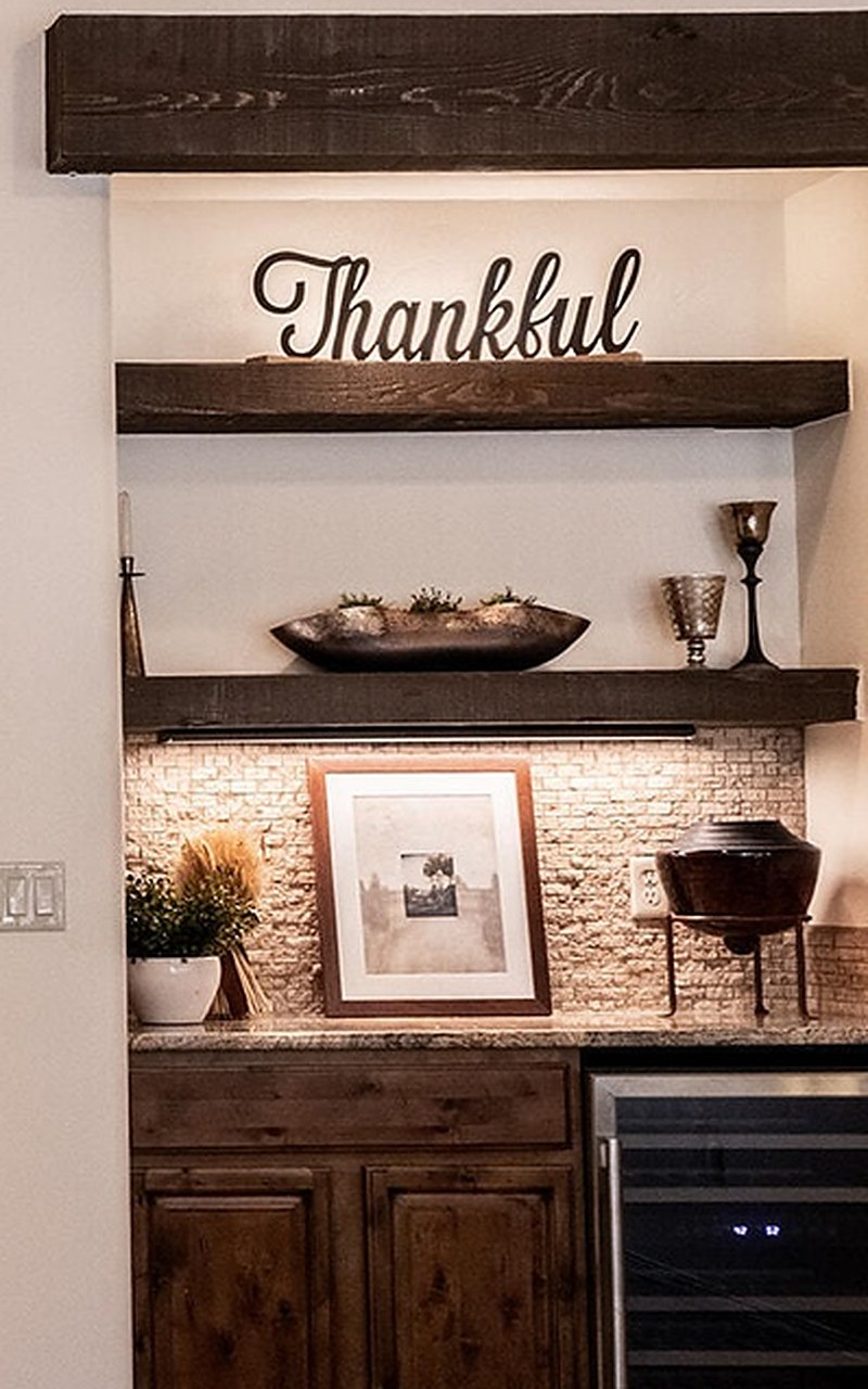 Close-up of styled floating shelves with a Thankful sign, décor and framed art over a wine bar, Sedona Boulders home staging Las Cruces NM