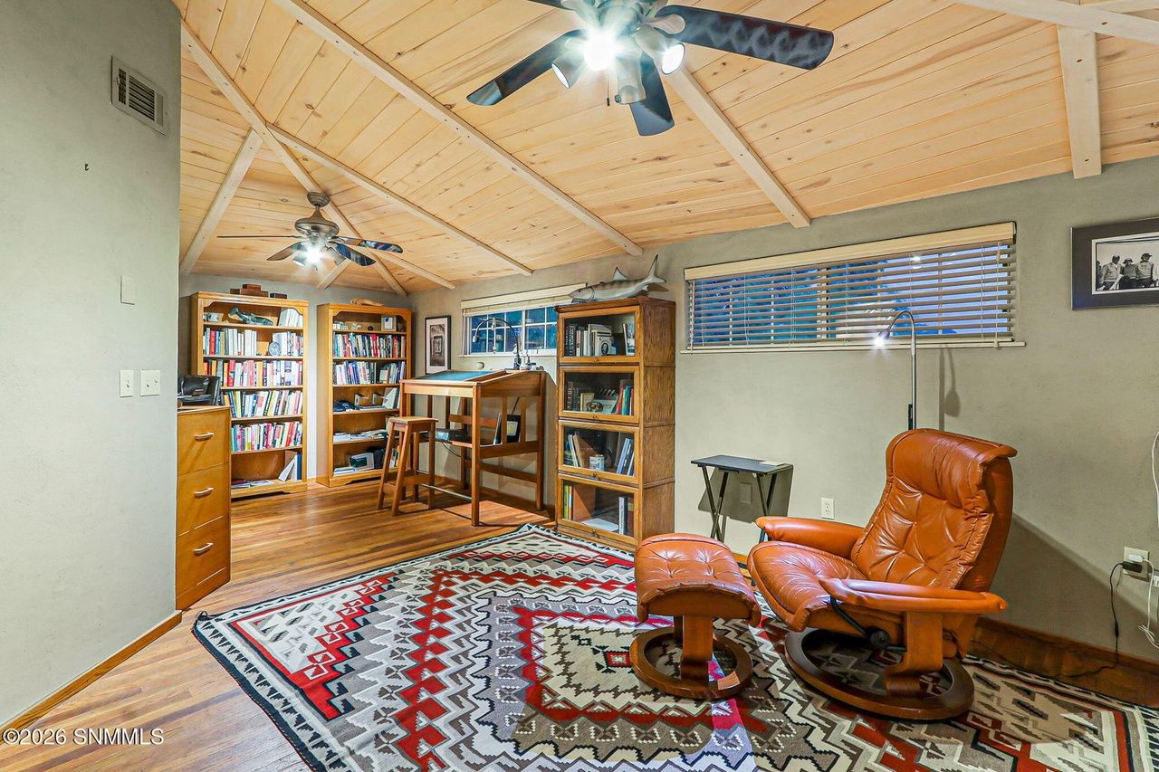 Den and library with leather chair and Navajo-style rug, Black Quartz Road Las Cruces