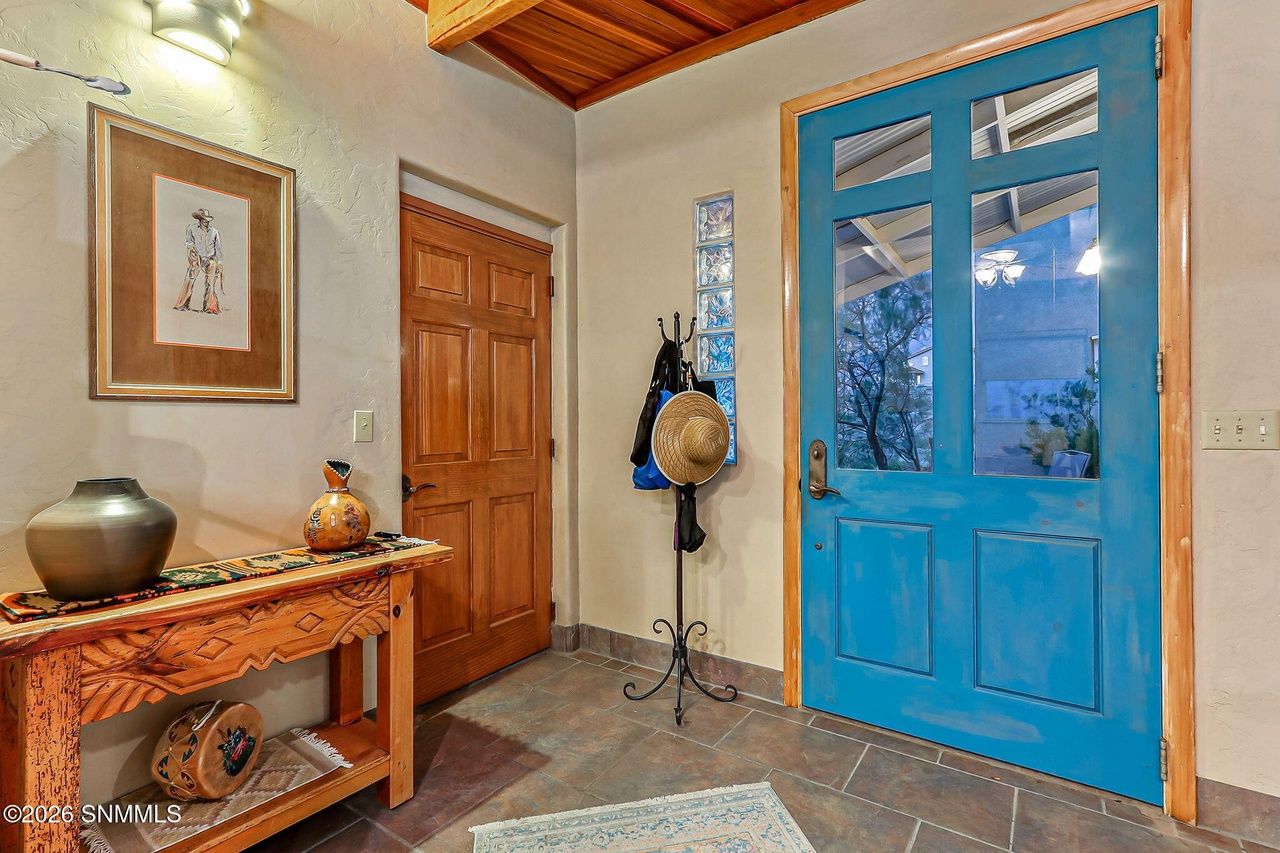 Styled entry with turquoise front door and console table, Las Cruces NM
