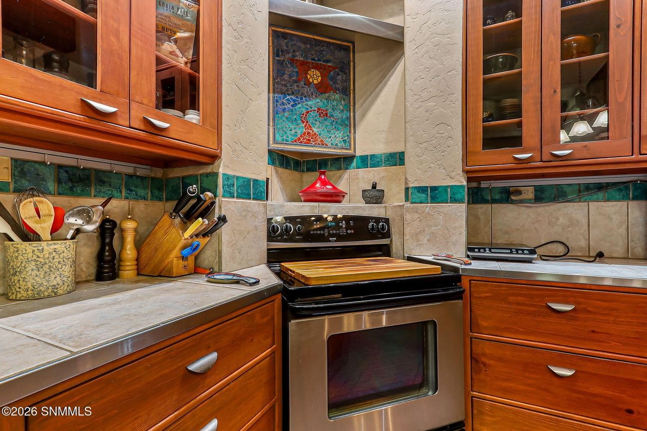 Styled Southwest kitchen with tile backsplash and wood cabinetry, Las Cruces NM